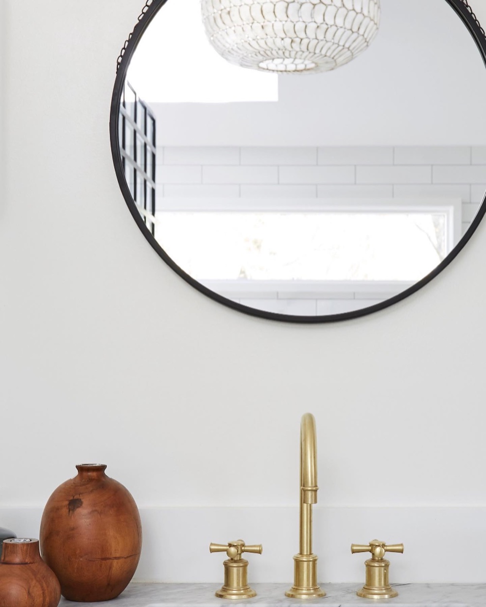 Materials detail / brass cross-handle faucet, round mirror, marble, luxury renovation and interior design by Martire Custom Homes