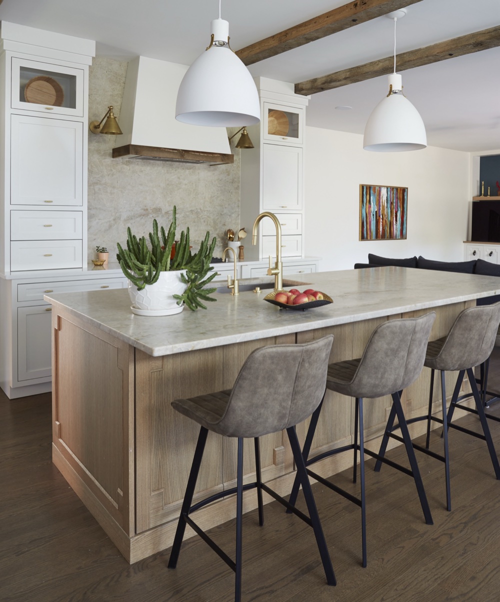 Kitchen with white oak island, cinnamon-veined quartzite counters, matte white pendants, reclaimed ceiling beams and brass faucets, by Martire Custom Homes